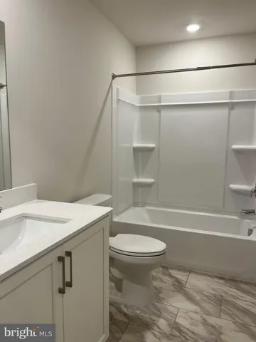 a bathroom with a sink a toilet and a bathtub