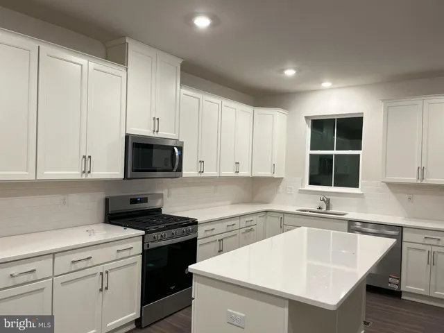 a kitchen with a sink stove and microwave