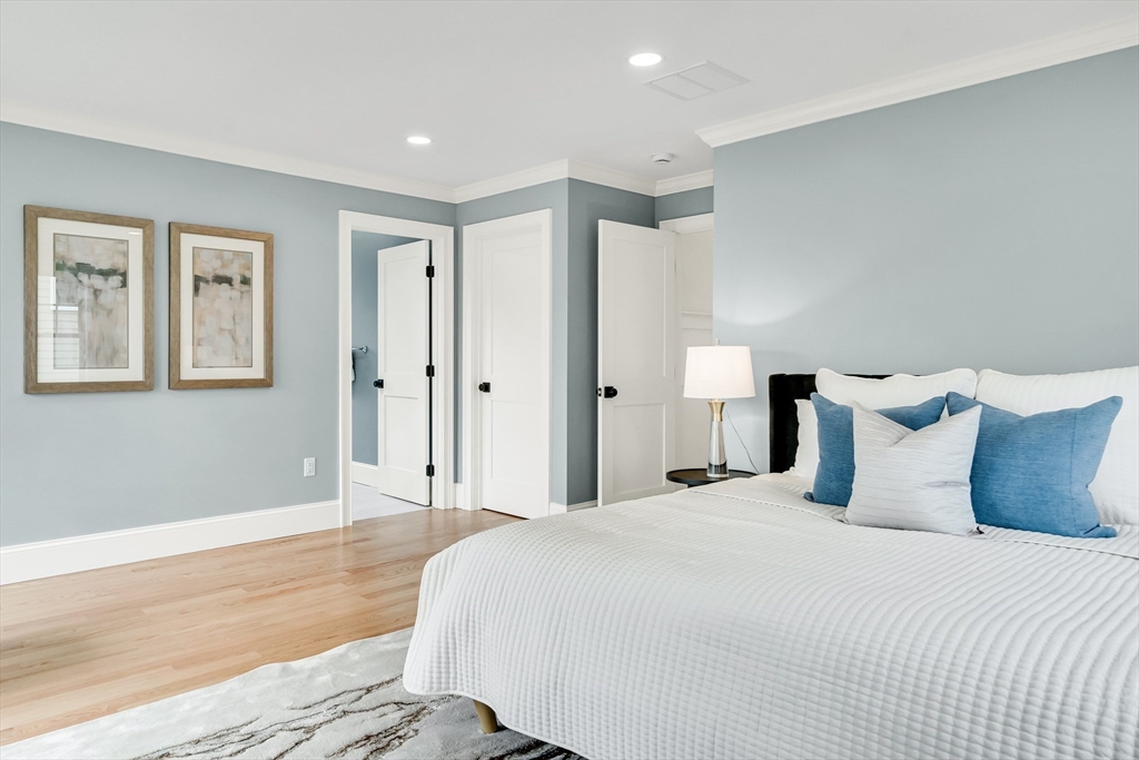 232 Lincoln Street Lexington, MA 02421 - Photo 18 of 41 a spacious bedroom with a bed and a painting on the wall