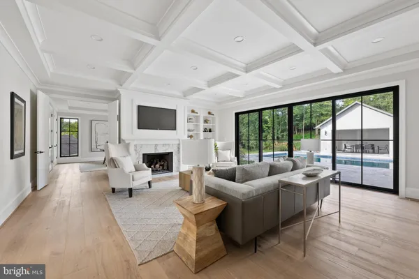 a living room with couches a dining table and chairs with wooden floor