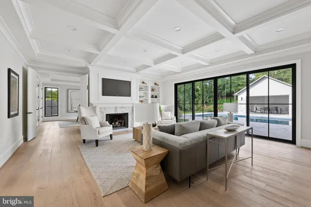 a living room with couches a dining table and chairs with wooden floor
