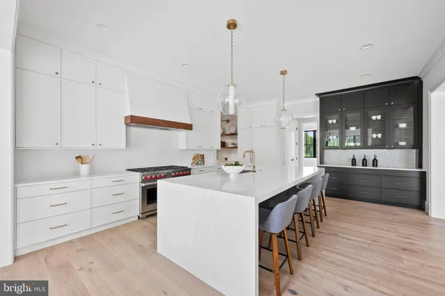 a living room with furniture a fireplace and a floor to ceiling window
