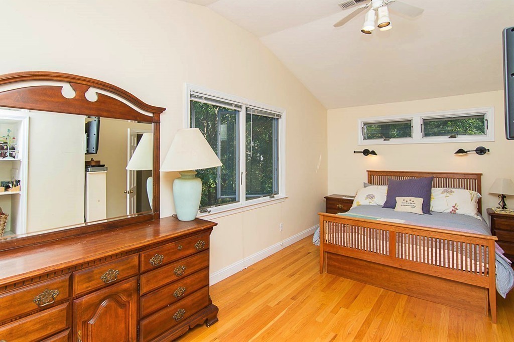 8 Framar Road Wellesley, MA 02481 - Photo 19 of 30 a bedroom with a bed a mirror on dresser and a window
