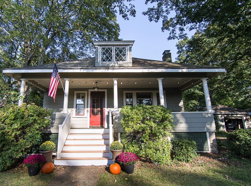8 Framar Road Wellesley, MA 02481 - Photo 2 of 30 a front view of a house with fountain windows and flower plants