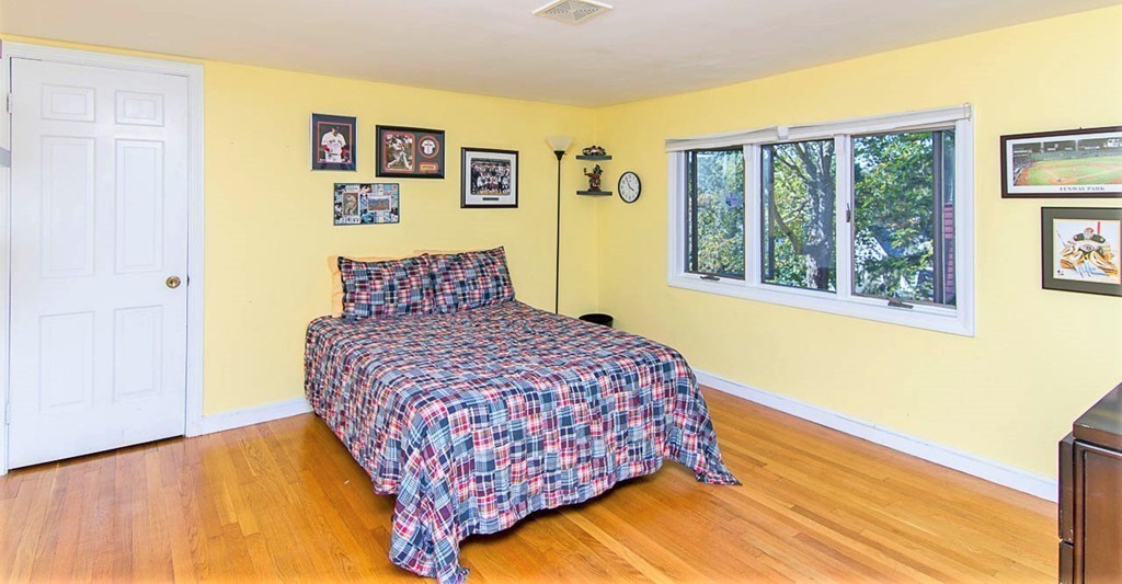 8 Framar Road Wellesley, MA 02481 - Photo 25 of 30 a bedroom with a bed and wooden floor
