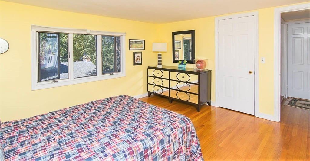 8 Framar Road Wellesley, MA 02481 - Photo 26 of 30 a bedroom with a bed and wooden floor