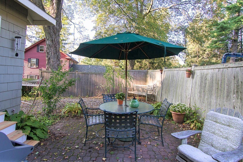8 Framar Road Wellesley, MA 02481 - Photo 29 of 30 a view of patio with a table and chairs under an umbrella