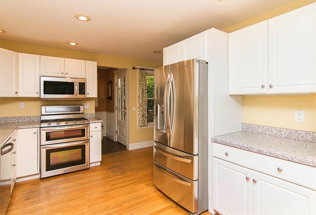 8 Framar Road Wellesley, MA 02481 - Photo 9 of 30 a kitchen with kitchen island a counter top space stainless steel appliances and cabinets