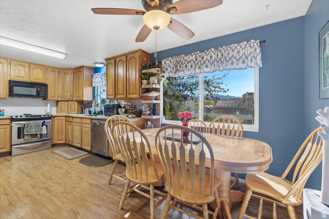 1095 Park Avenue Logan, UT 84321 - Photo 4 of 27 Dining space with ceiling fan, light wood finished floors, and a textured ceiling