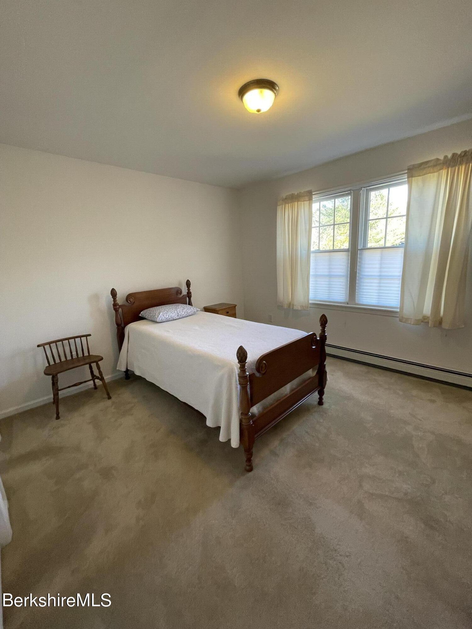 181 Main Road Monterey, MA 01230 - Photo 12 of 63 a bed sitting in a spacious bedroom next to a window