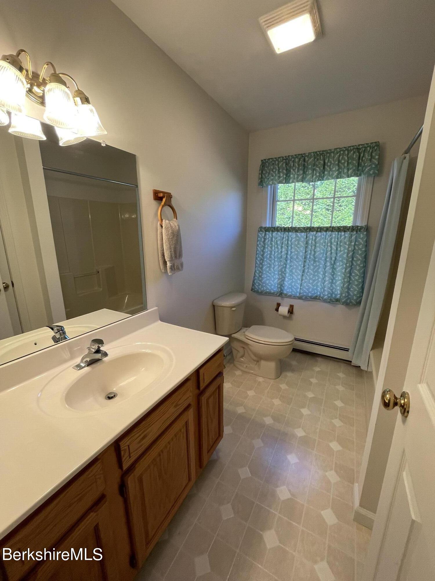 181 Main Road Monterey, MA 01230 - Photo 13 of 63 a bathroom with a sink vanity and mirror
