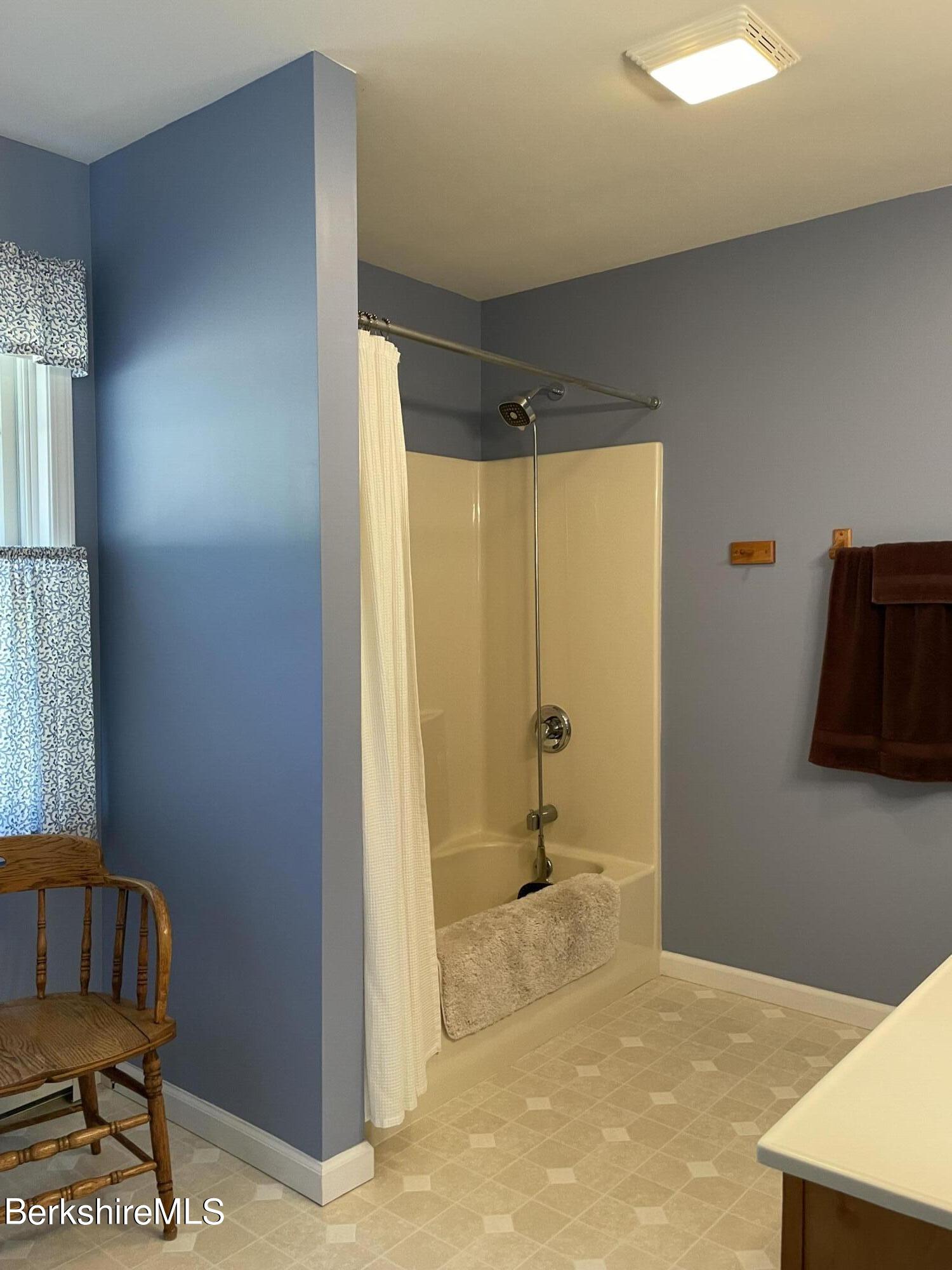 181 Main Road Monterey, MA 01230 - Photo 20 of 63 a bathroom with a bathtub and a shower