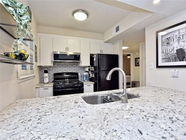 a kitchen with a refrigerator stove and a sink