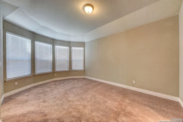 an empty room with a empty space and windows