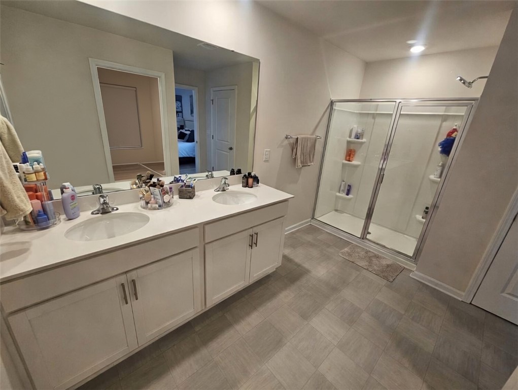 902 Ashwood Lane Easley, SC 29640 - Photo 25 of 39 A well-appointed primary bathroom featuring a spacious dual vanity and a walk-in shower.
