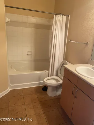 a bathroom with a sink a toilet and a shower