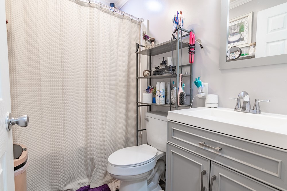 708 Sexton Gin Road Iva, SC 29655 - Photo 14 of 20 This bathroom features a contemporary vanity with a sleek faucet and a practical shower.