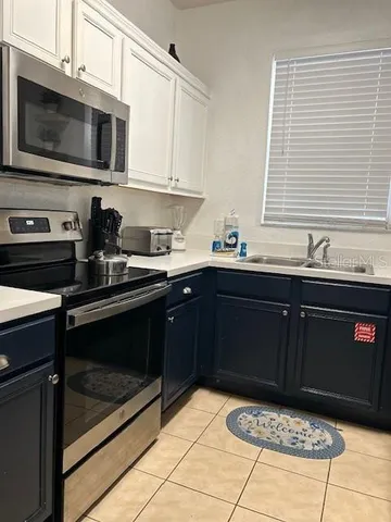 a kitchen with a sink stove and microwave
