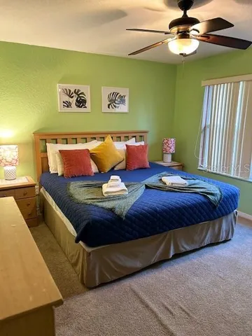 a bedroom with a bed dresser and a window
