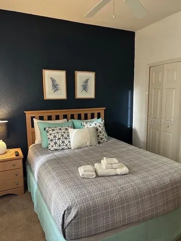 a bedroom with a bed and a night stand