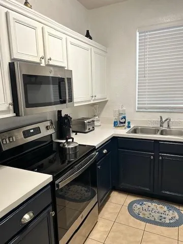 a kitchen with a sink stove and microwave