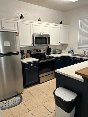 a kitchen with a sink appliances and cabinets