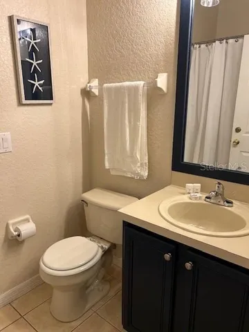 a bathroom with a sink a toilet and mirror