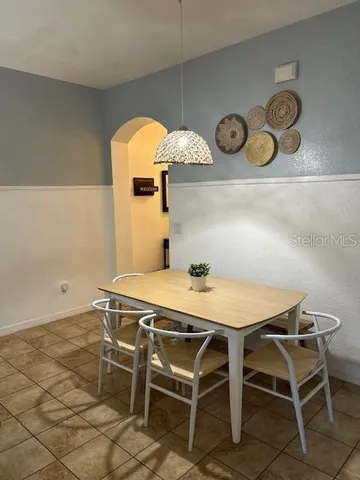 a dining room with a table and chairs