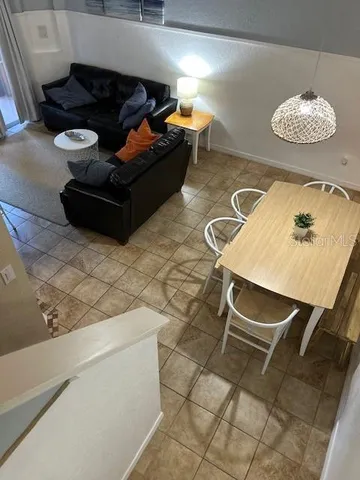 a living room with furniture and next to a window