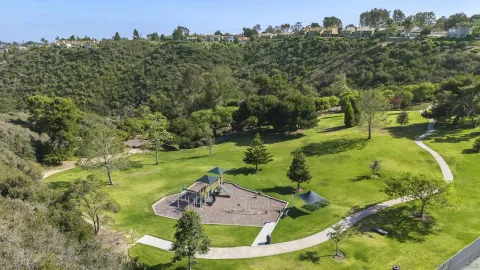 an aerial view of residential houses with outdoor space