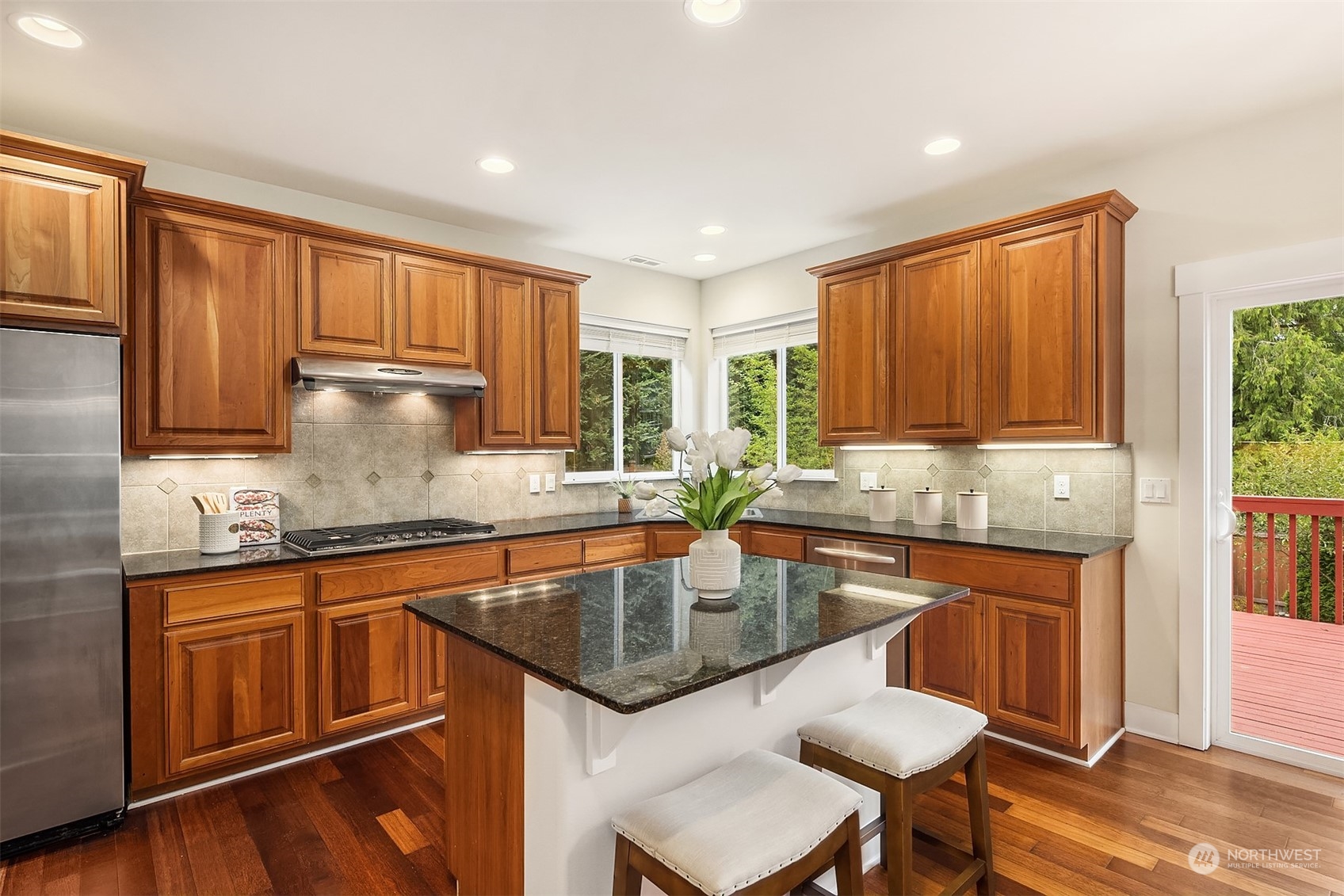 5004 Northeast 25th Street Renton, WA 98059 - Photo 15 of 37 a kitchen with granite countertop sink stove top oven and microwave