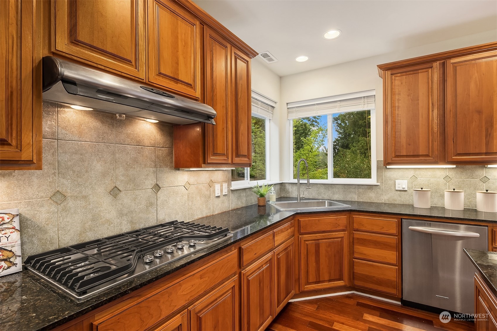 5004 Northeast 25th Street Renton, WA 98059 - Photo 16 of 37 a kitchen with granite countertop a stove sink and cabinets