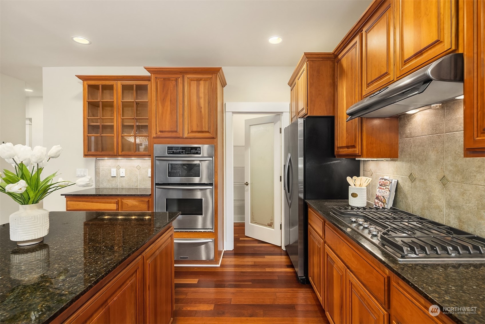 5004 Northeast 25th Street Renton, WA 98059 - Photo 18 of 37 a kitchen with granite countertop stainless steel appliances and wooden cabinets