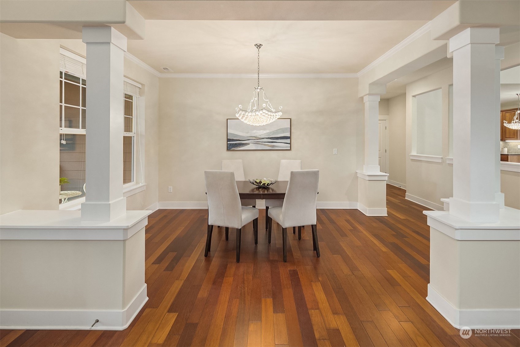5004 Northeast 25th Street Renton, WA 98059 - Photo 19 of 37 a dining room with wooden floor a chandelier a wooden table and chairs
