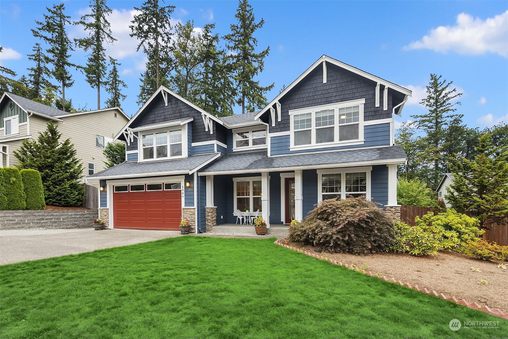 5004 Northeast 25th Street Renton, WA 98059 - Photo 2 of 37 a front view of a house with a yard and trees