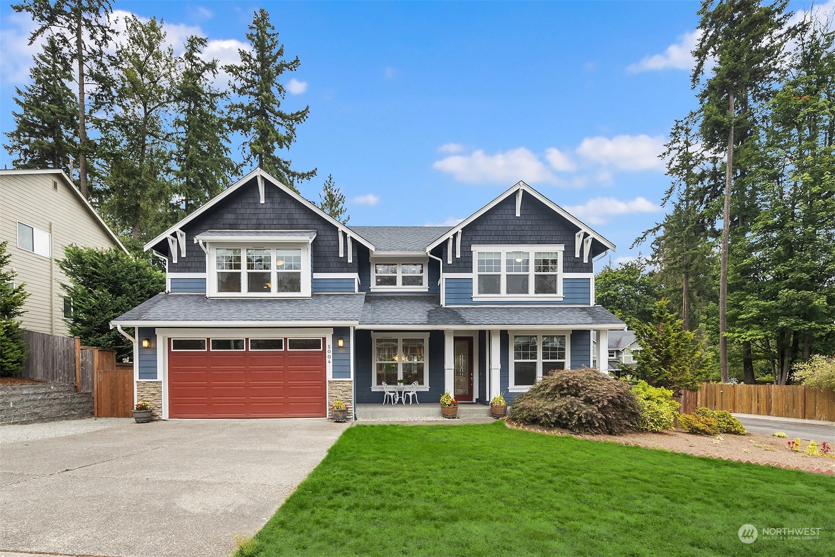 5004 Northeast 25th Street Renton, WA 98059 - Photo 3 of 37 a front view of a house with a garden and yard