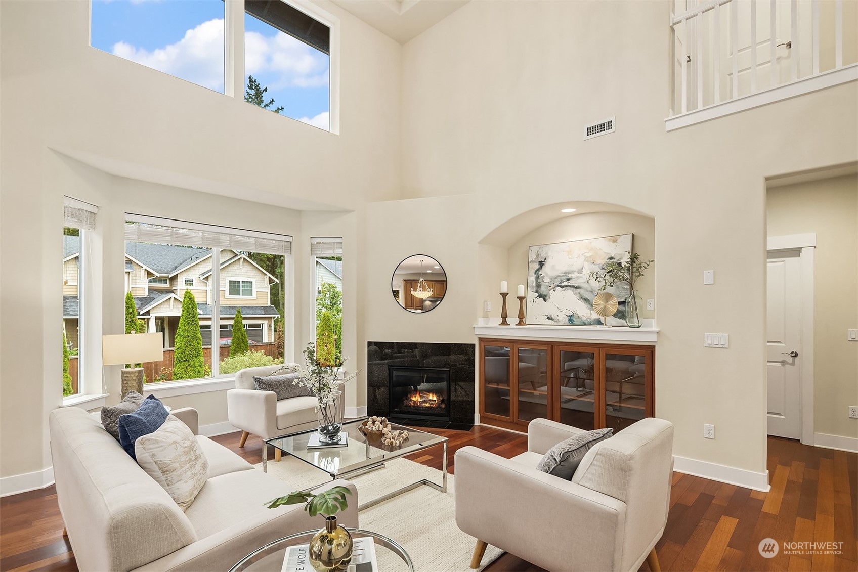 5004 Northeast 25th Street Renton, WA 98059 - Photo 9 of 37 a living room with furniture a fireplace and a large mirror with wooden floor
