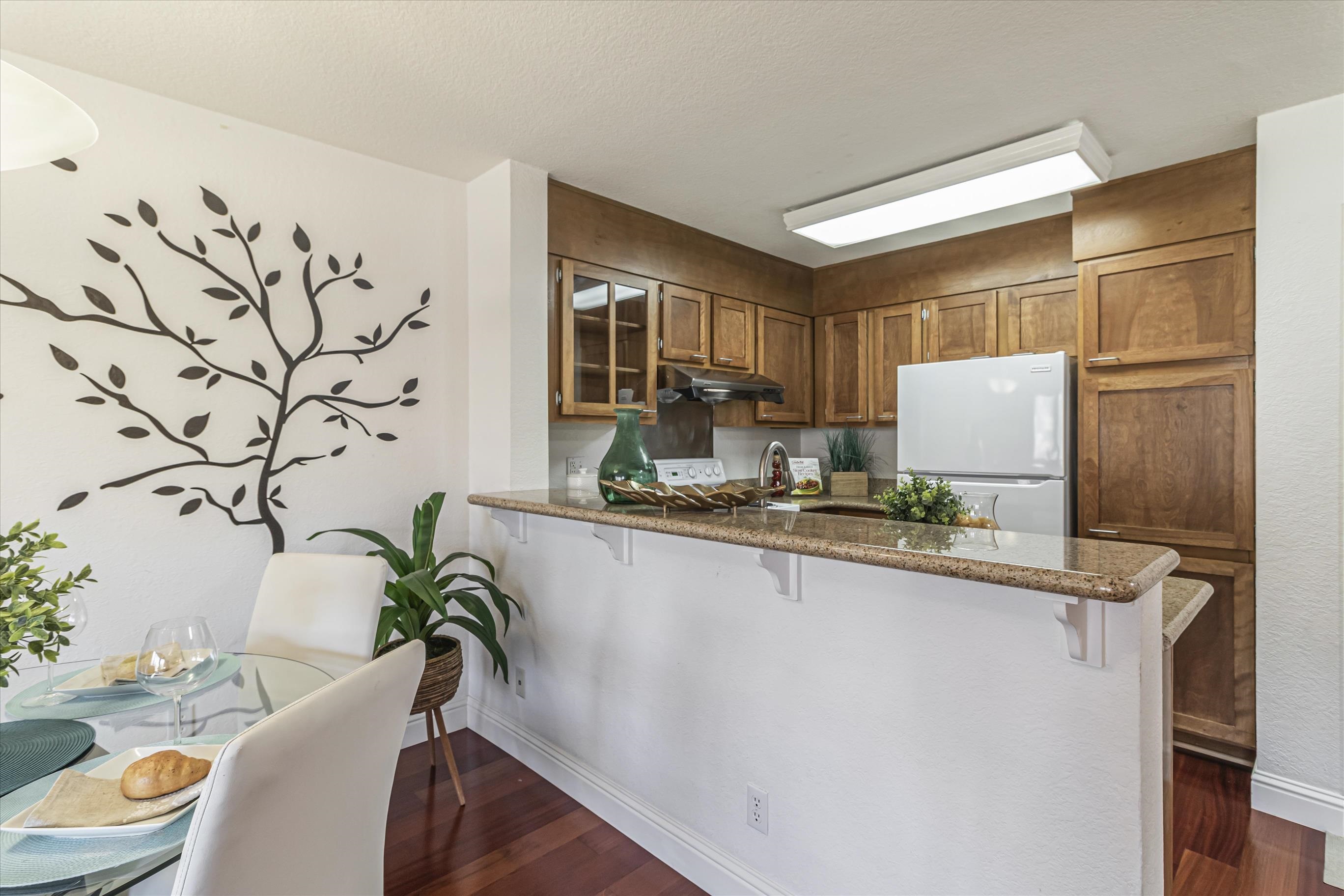 39059 Guardino Drive, Unit 206 Fremont, CA 94538 - Photo 11 of 37 a living room with granite countertop furniture a sink and a potted plant