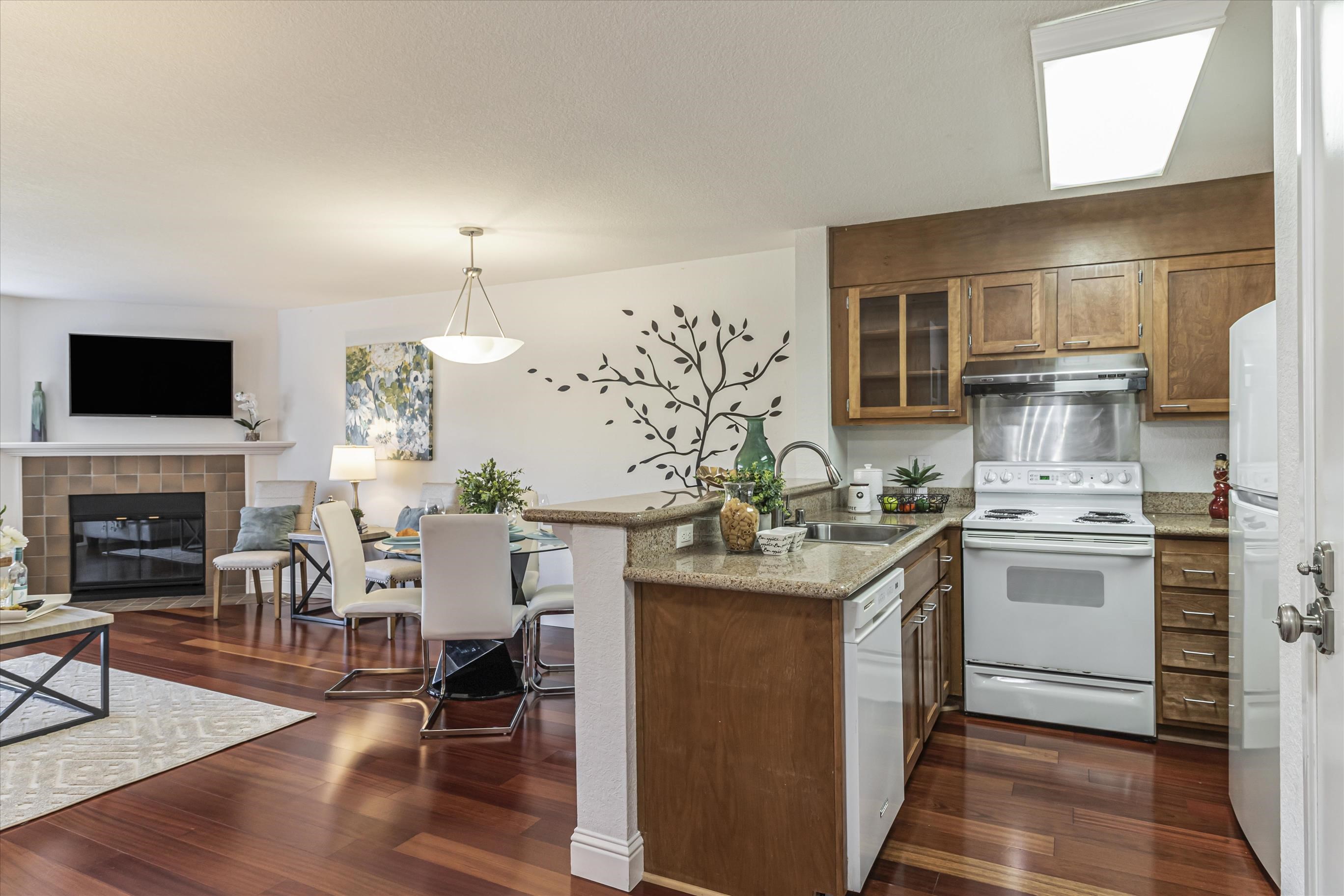 39059 Guardino Drive, Unit 206 Fremont, CA 94538 - Photo 12 of 37 a kitchen with a sink cabinets and wooden floor