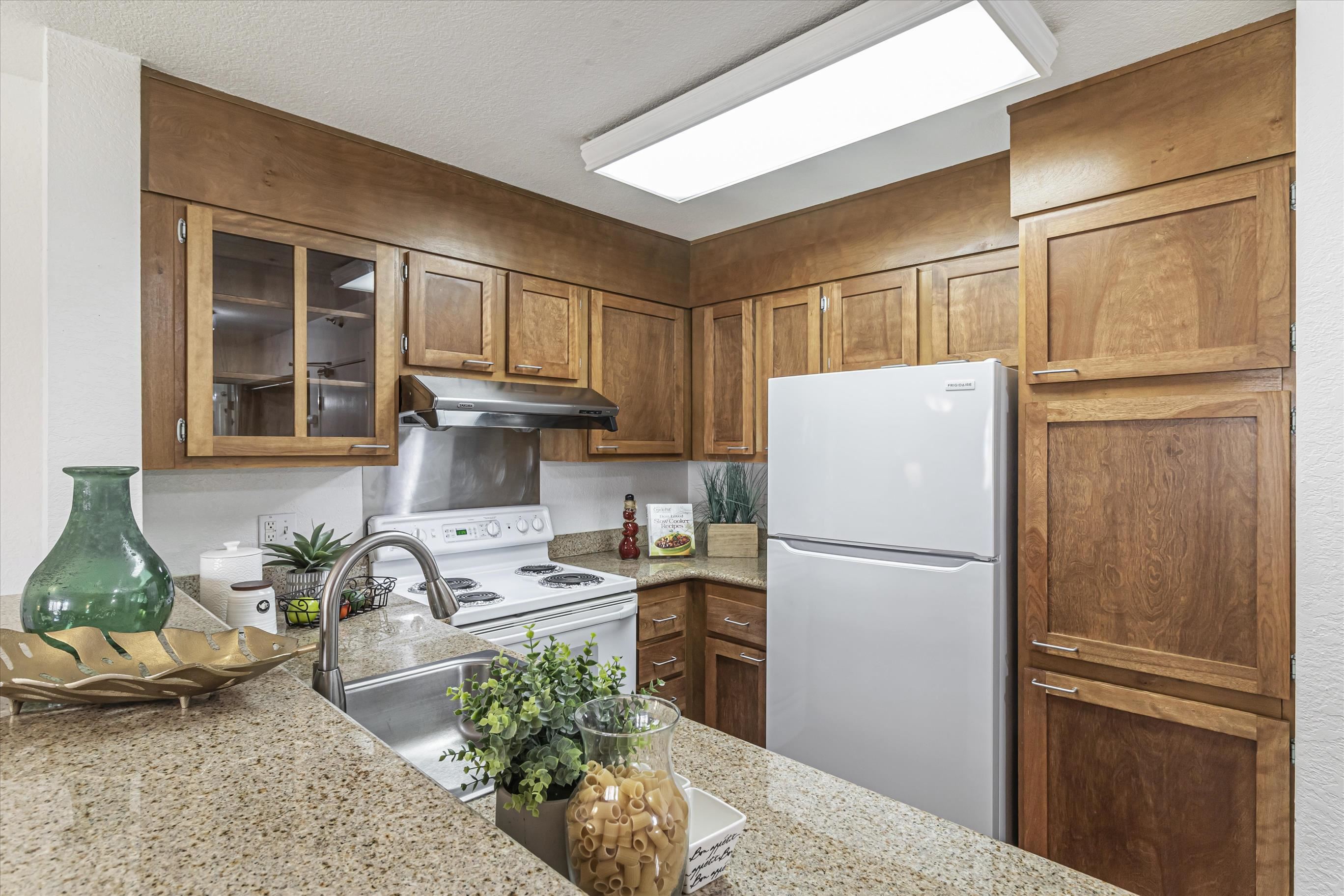39059 Guardino Drive, Unit 206 Fremont, CA 94538 - Photo 13 of 37 a kitchen with stainless steel appliances granite countertop a refrigerator sink and stove