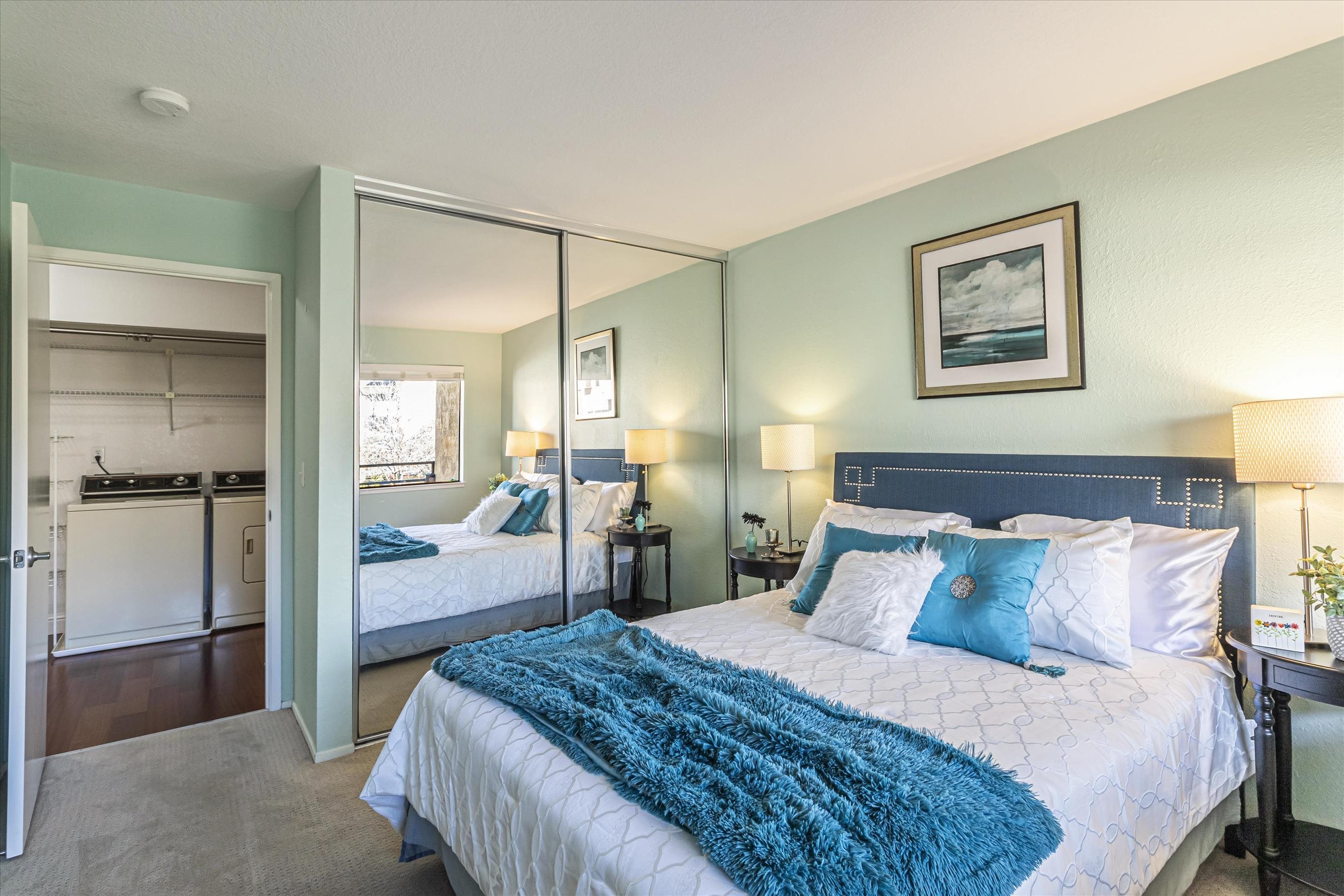 39059 Guardino Drive, Unit 206 Fremont, CA 94538 - Photo 17 of 37 a bedroom with a bed and a mirror