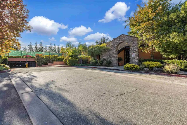 a front view of a house with a yard and a garden