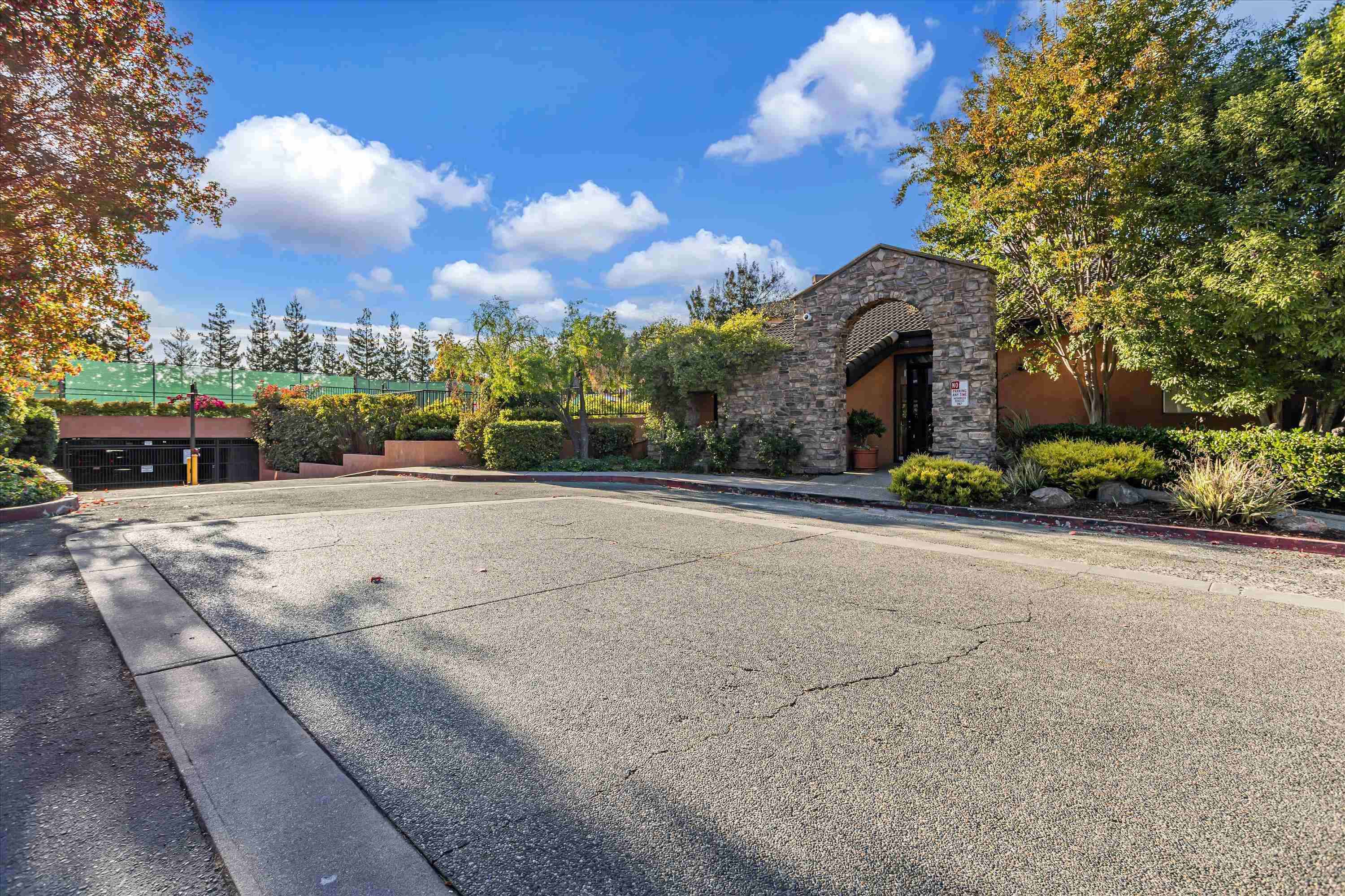 39059 Guardino Drive, Unit 206 Fremont, CA 94538 - Photo 27 of 37 a front view of a house with a yard and a garden