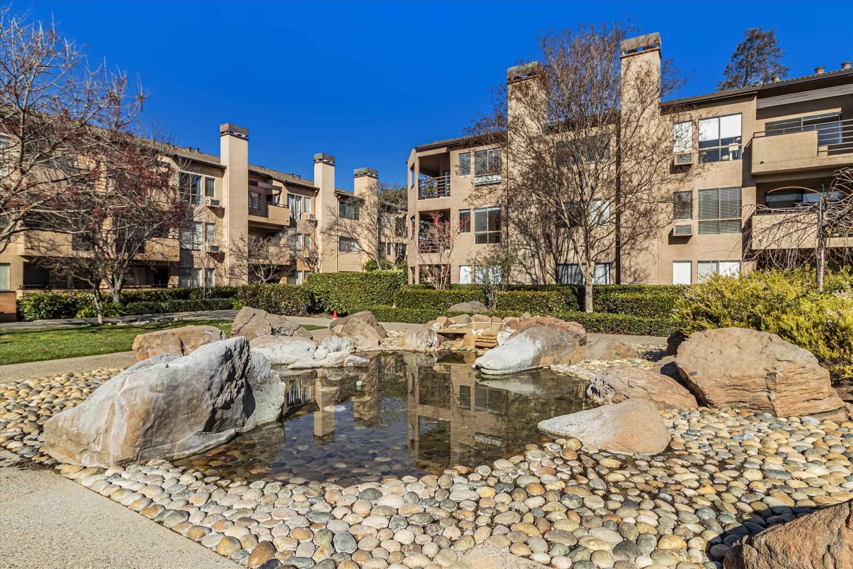 39059 Guardino Drive, Unit 206 Fremont, CA 94538 - Photo 33 of 37 a view of a building with a yard