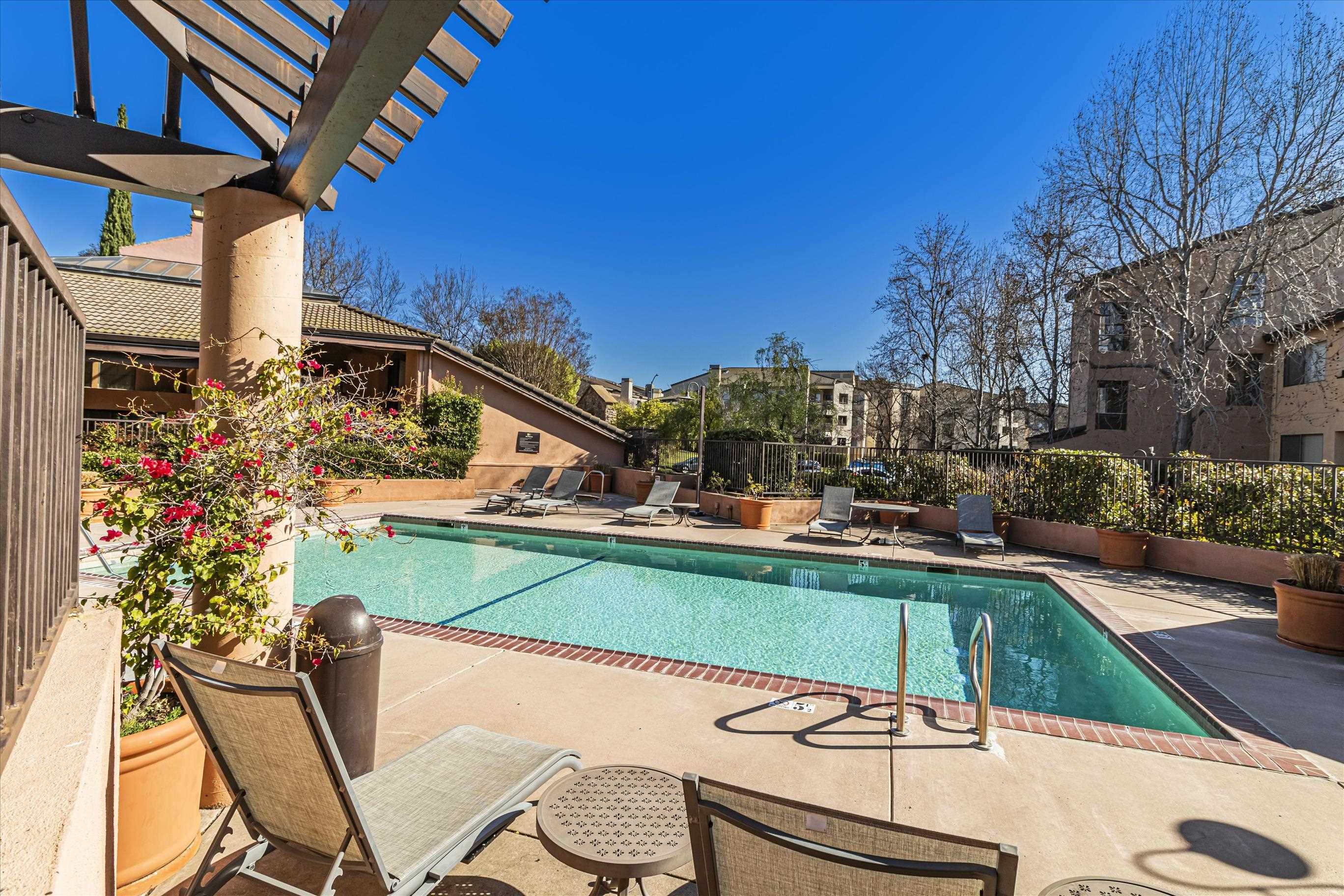 39059 Guardino Drive, Unit 206 Fremont, CA 94538 - Photo 35 of 37 a view of a patio with table and chairs and potted plants