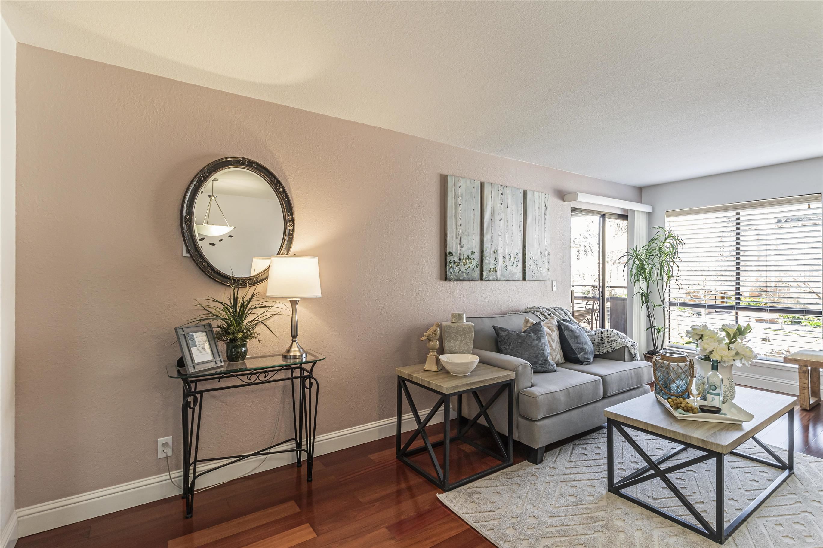 39059 Guardino Drive, Unit 206 Fremont, CA 94538 - Photo 8 of 37 a living room with furniture a rug a lamp and a window