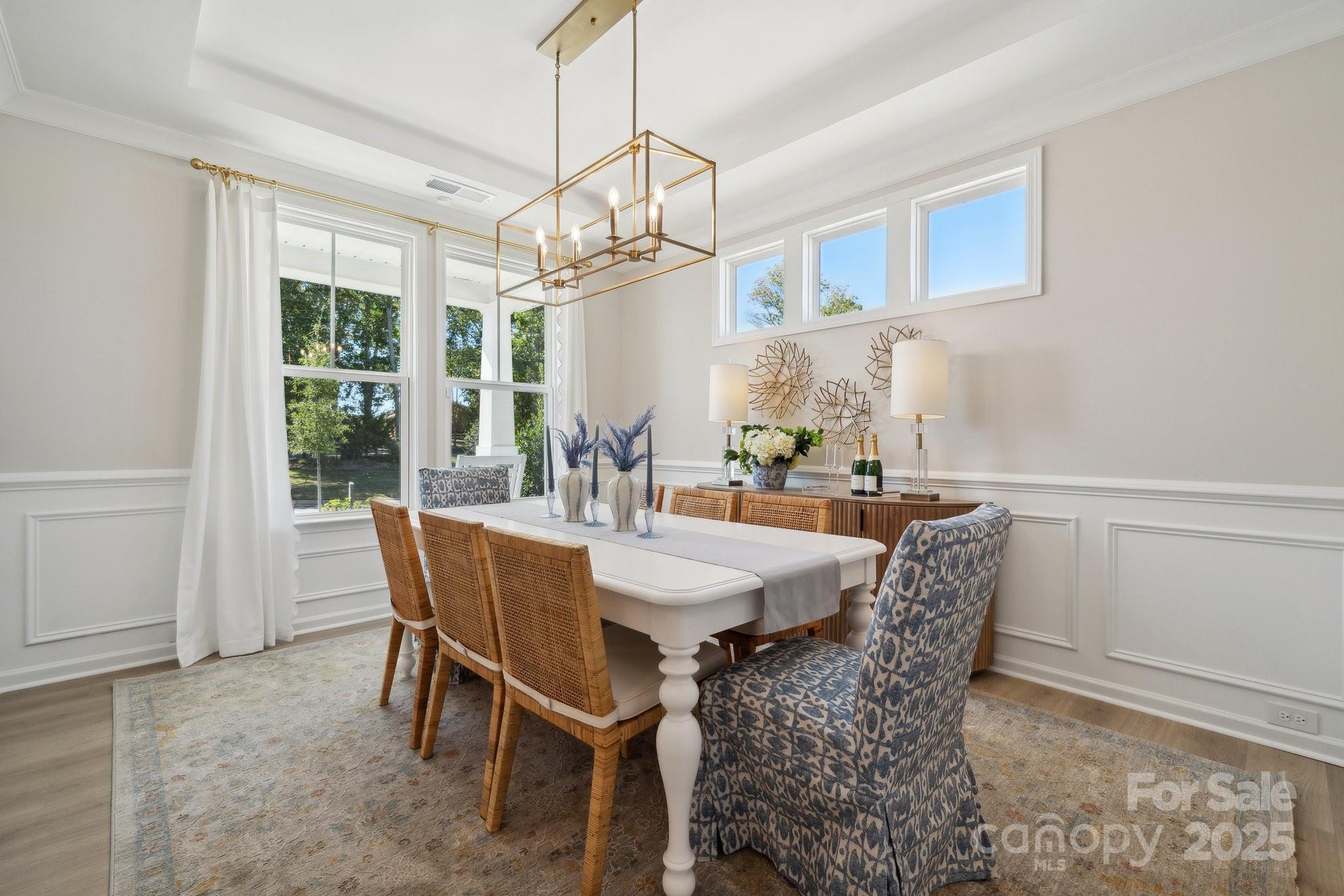 1464 Hubert Graham Way Tega Cay, SC 29708 - Photo 8 of 25 a dining room with furniture a chandelier and window