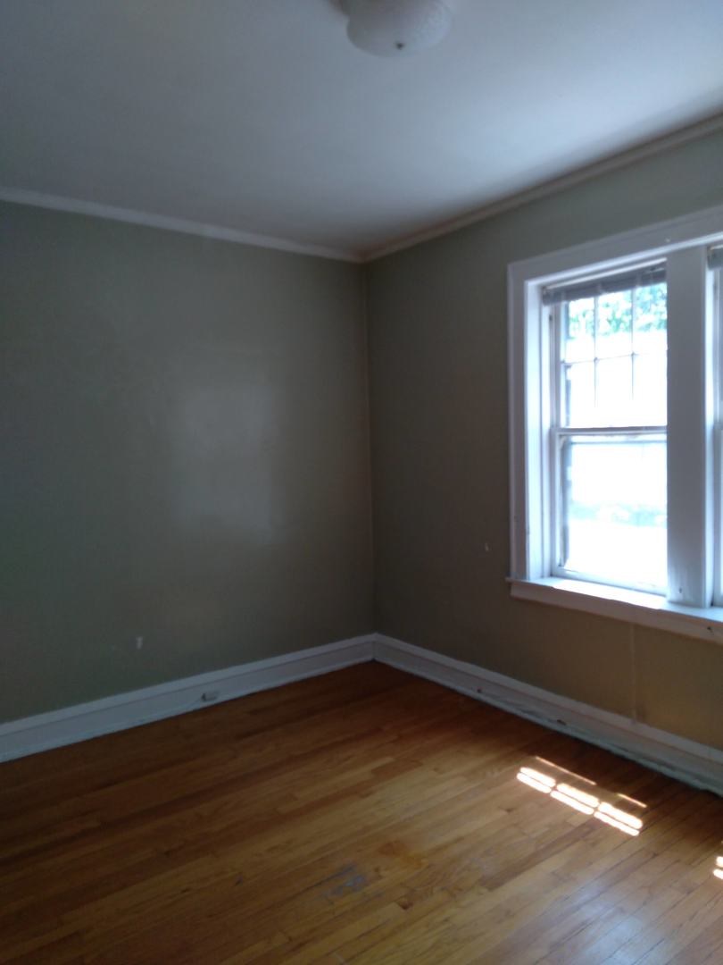 803 Case Street, Unit 3 Evanston, IL 60202 - Photo 4 of 12 a view of an empty room with wooden floor and a window