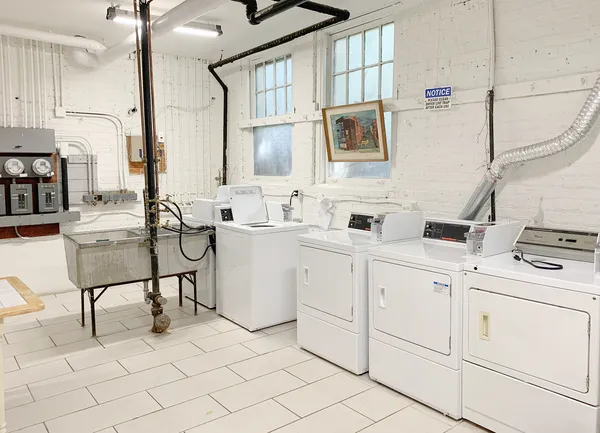 a kitchen with cabinets and chairs