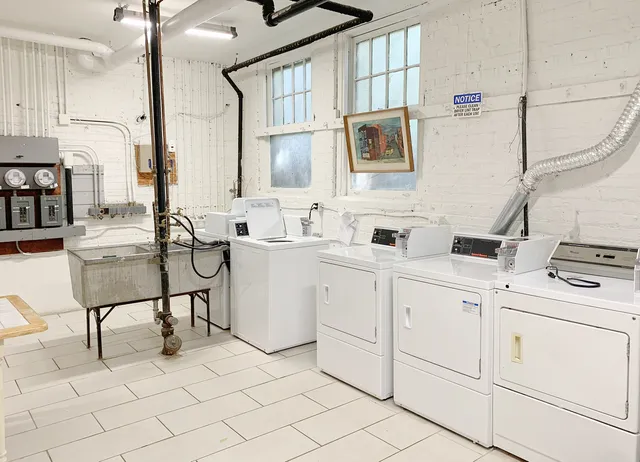 a kitchen with cabinets and chairs